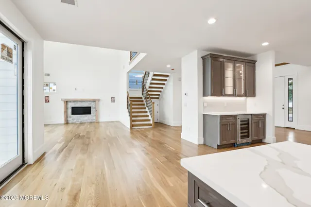 a large kitchen with stainless steel appliances kitchen island granite countertop a sink stove and refrigerator