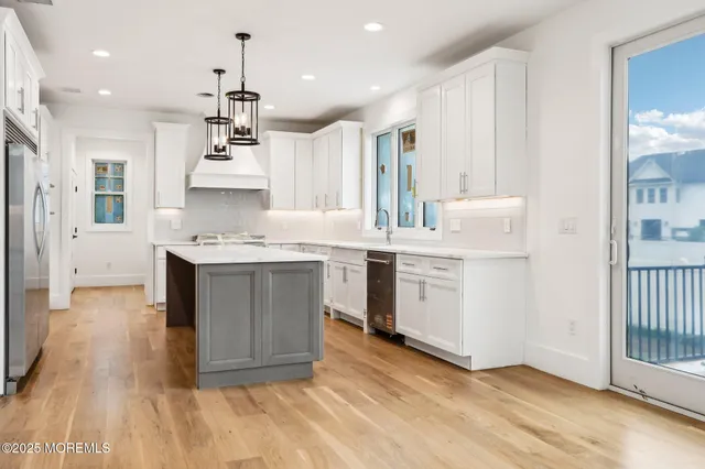 a large kitchen with a lot of counter space and stainless steel appliances