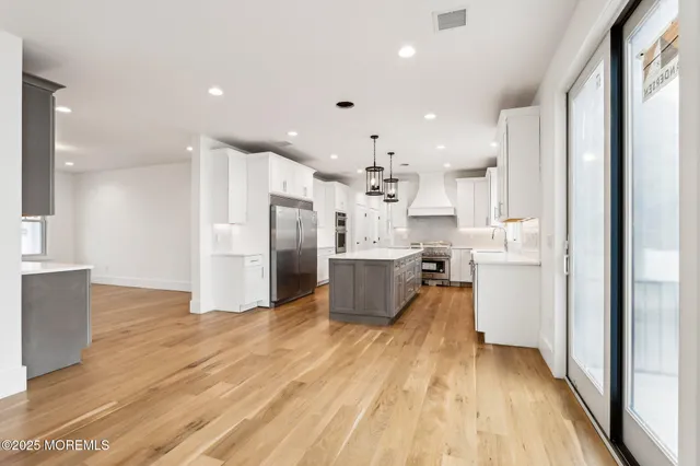 a kitchen with stainless steel appliances granite countertop a stove and a sink