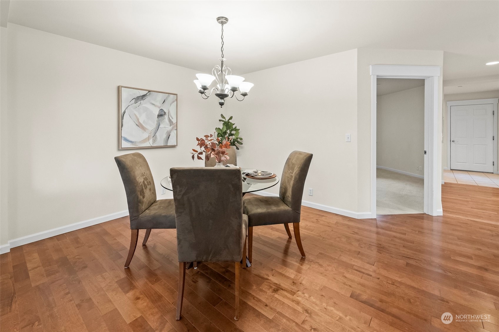 91 East Soderberg Road, Unit C8 Allyn, WA 98524 - Photo 12 of 39 a view of a dining room with furniture a chandelier and wooden floor