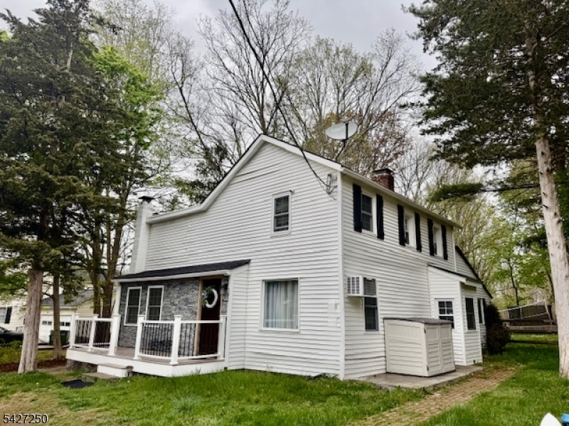 182 Stephensburg Road Port Murray, NJ 07865 - Photo 1 of 25 a view of a white house next to a yard with big trees