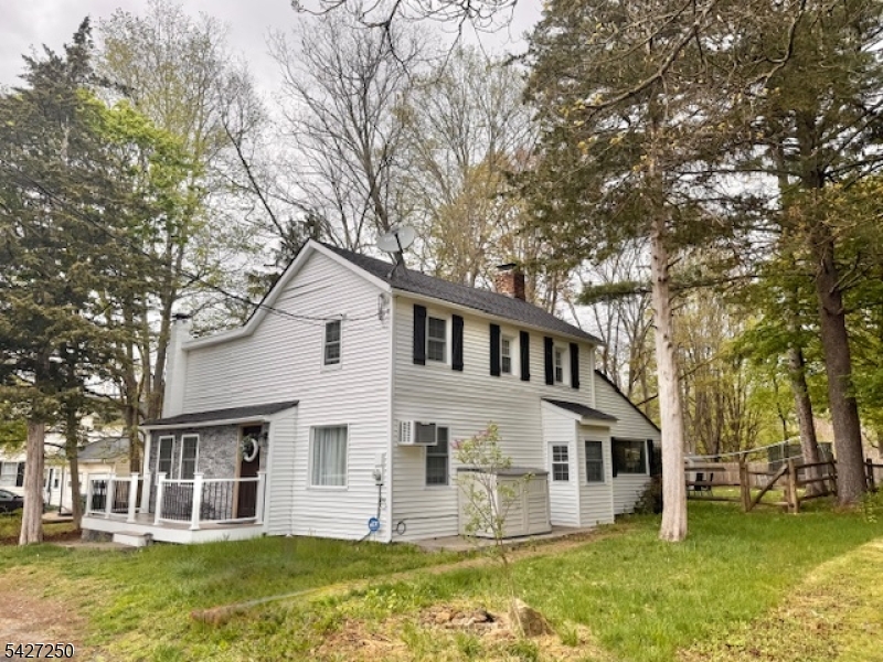 182 Stephensburg Road Port Murray, NJ 07865 - Photo 4 of 25 a front view of a house with a garden and trees