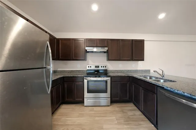 a kitchen with a sink and a stove top oven