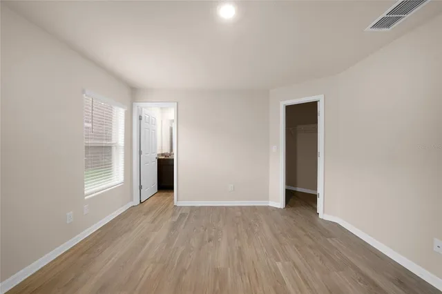 a view of wooden floor and windows in a room