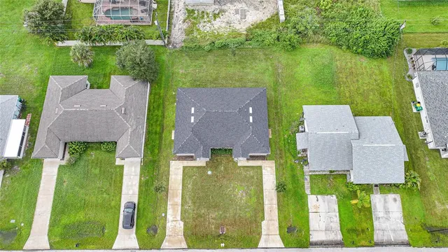 an aerial view of a house with a yard basket ball court and outdoor seating