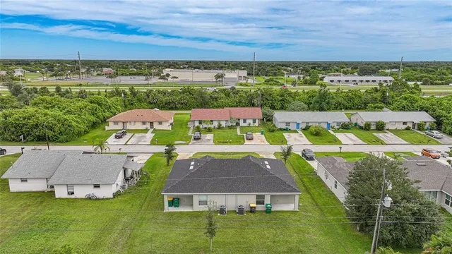 an aerial view of a house with big yard