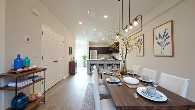 a dining room with furniture and wooden floor