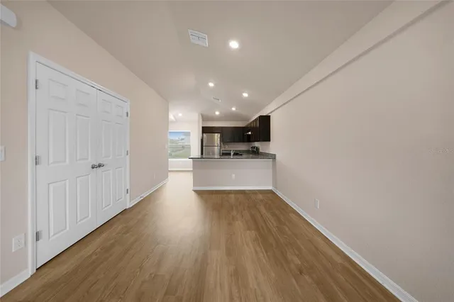 a view of a kitchen with a sink and wooden floor
