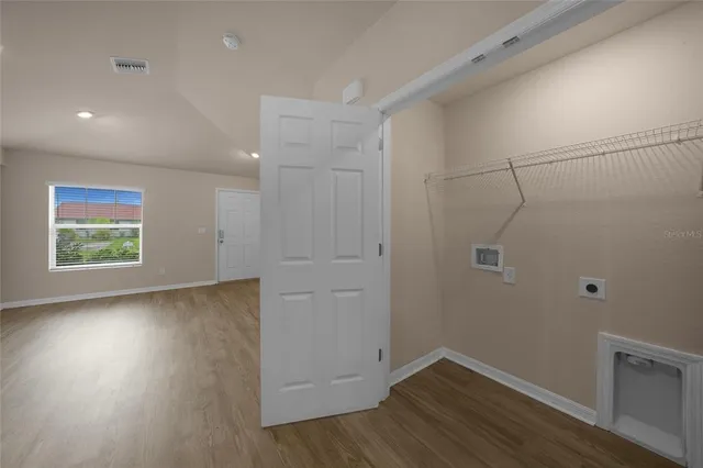 a view of room with hardwood floor and window