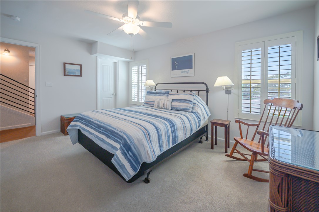 620 Fulton Beach Road, Unit 708 Rockport, TX 78382 - Photo 20 of 38 a spacious bedroom with a bed and a chandelier
