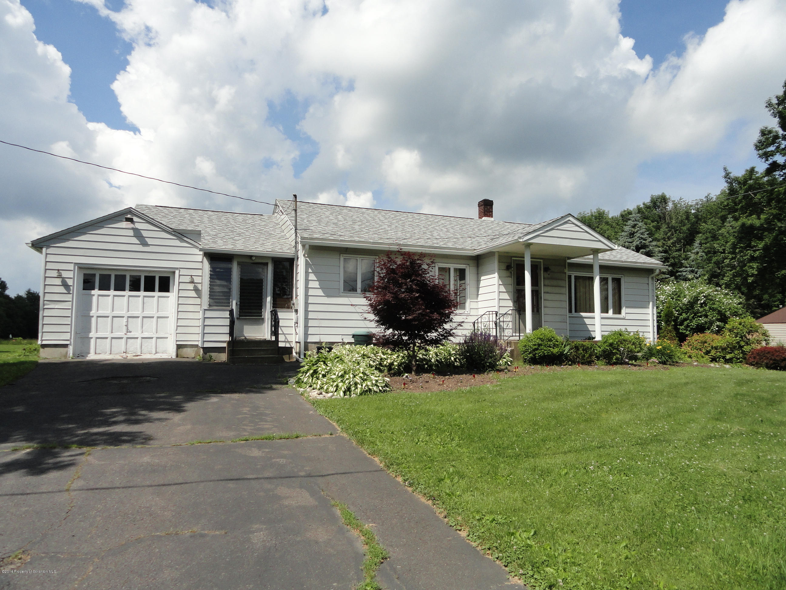 2310 Quicktown Road Moscow, PA 18444 - Photo 47 of 52 a front view of a house with a yard and garage