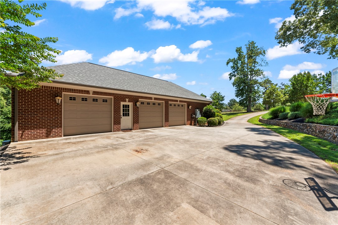 579 Terrapin Crossing Road Pickens, SC 29671 - Photo 48 of 50 A spacious driveway leads to a triple garage on the main level offering ample parking and convenience.