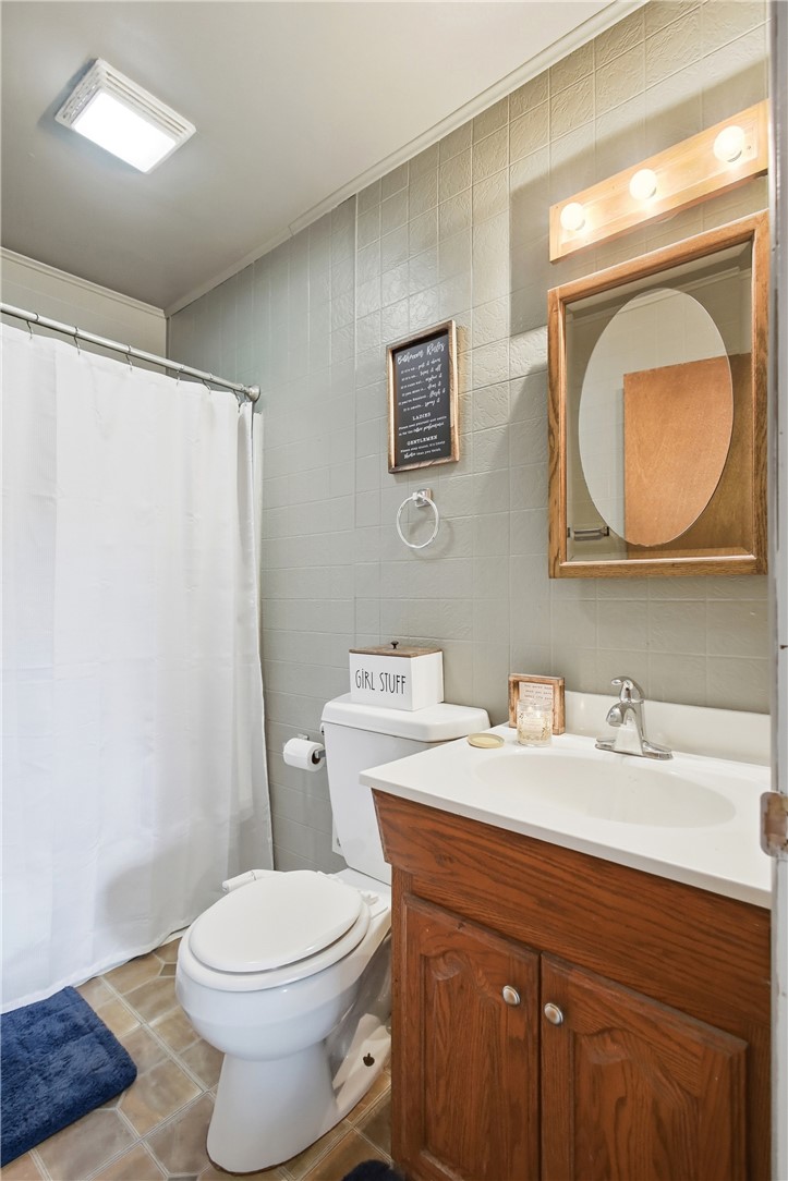 2745 Share Street Springfield, OH 45505 - Photo 20 of 28 This bathroom features practical design with tiled walls and a functional vanity area.