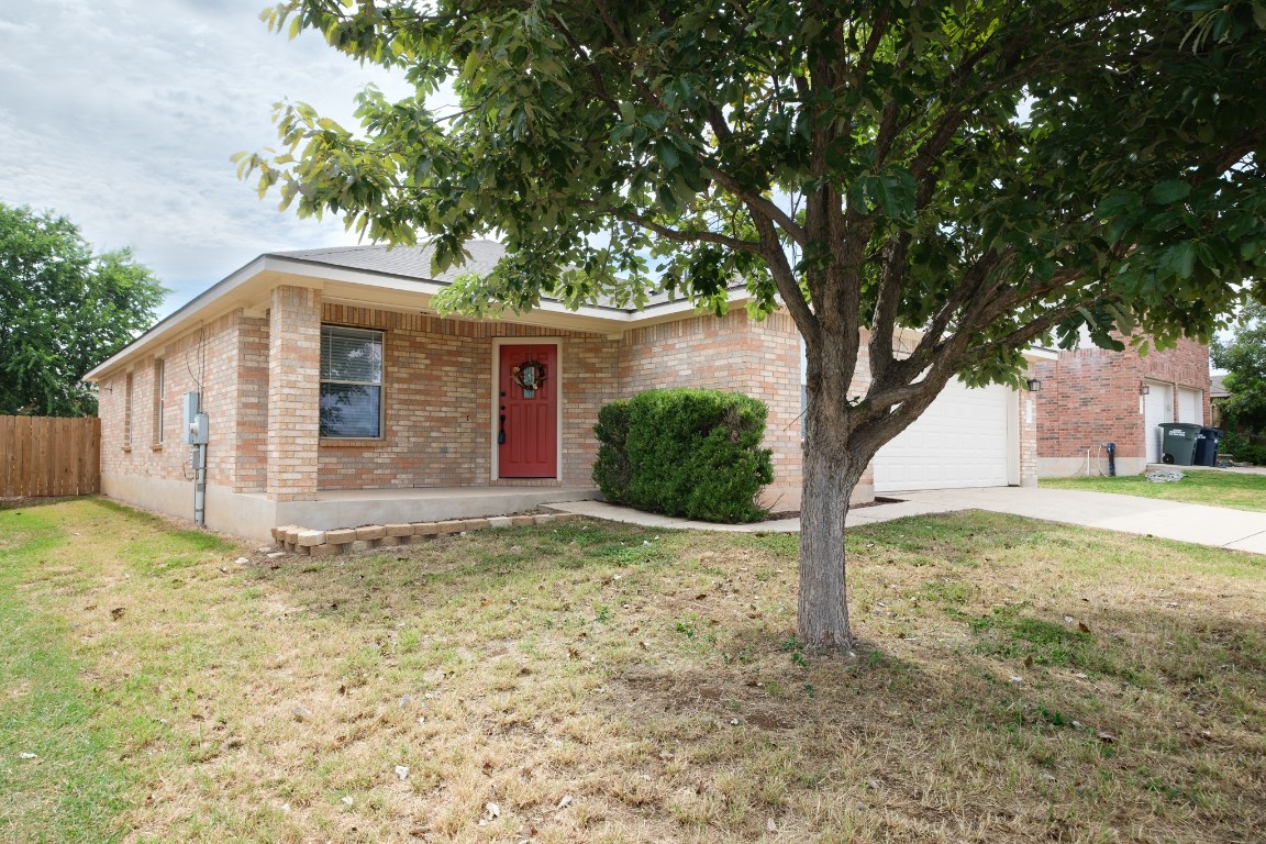 View of front of house with brick siding, concrete driveway, and an attached garage