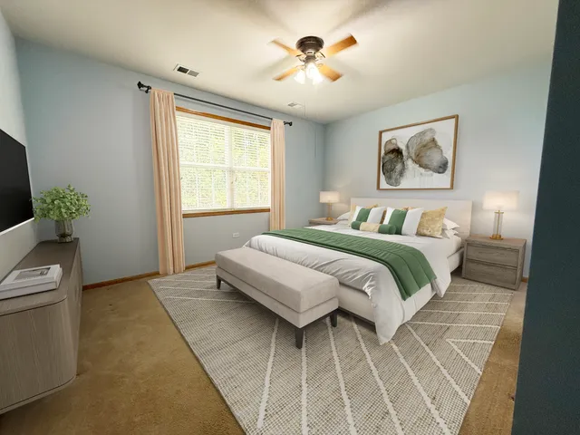 a bedroom with a bed and a painting on the wall