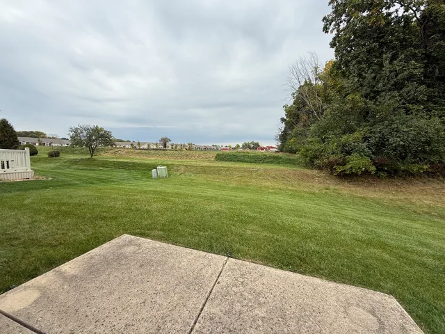a view of a garden with a building in the background