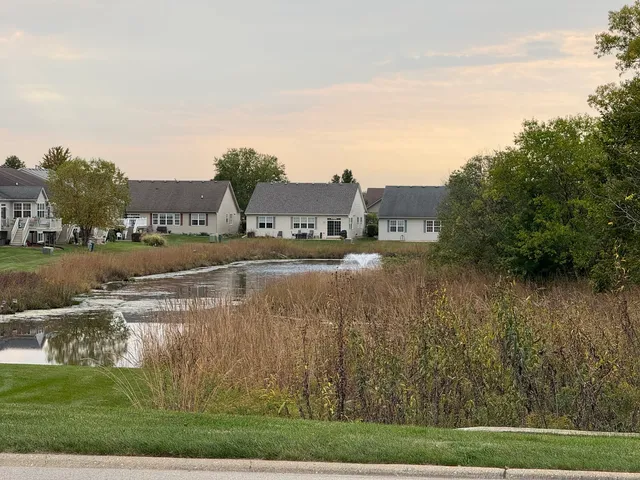 a view of a lake with houses in the background