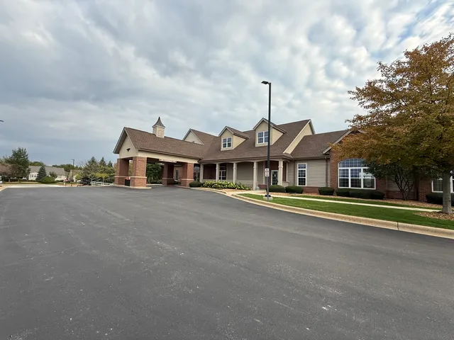a front view of a house with a large trees