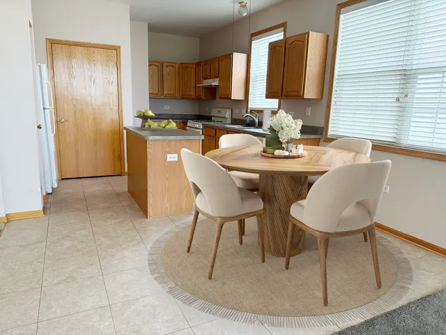 a dining room with furniture and a window