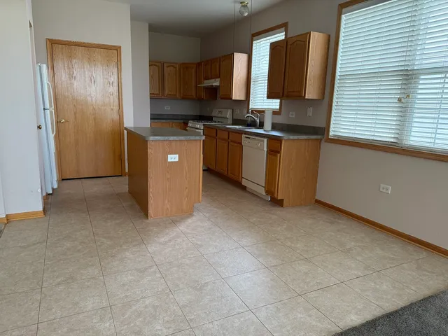 a kitchen with stainless steel appliances a sink stove and refrigerator