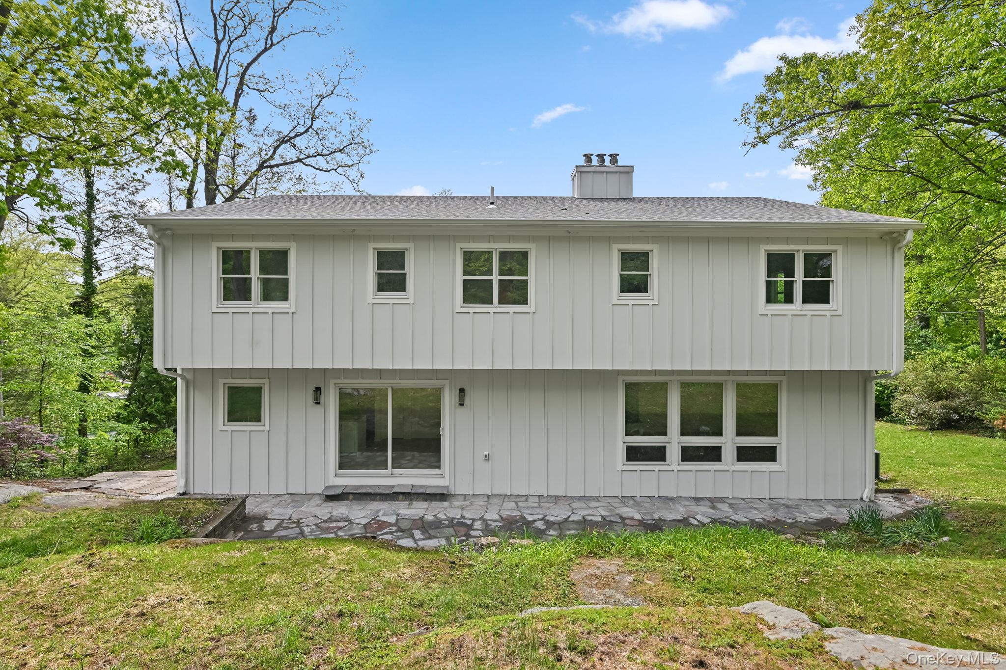 24 Country Road Mamaroneck, NY 10543 - Photo 29 of 37 a front view of a house with a garden