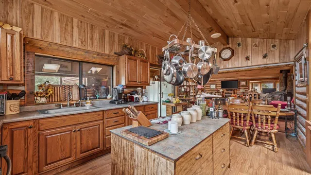 a kitchen with stainless steel appliances granite countertop a sink dishwasher and cabinets with wooden floor