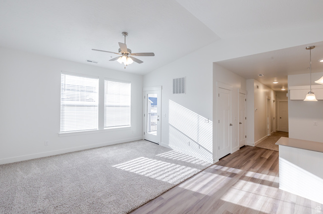 4662 Poplar Way, Unit Q301 Mapleton, UT 84664 - Photo 10 of 18 Unfurnished room featuring vaulted ceiling, light wood finished floors, and a ceiling fan