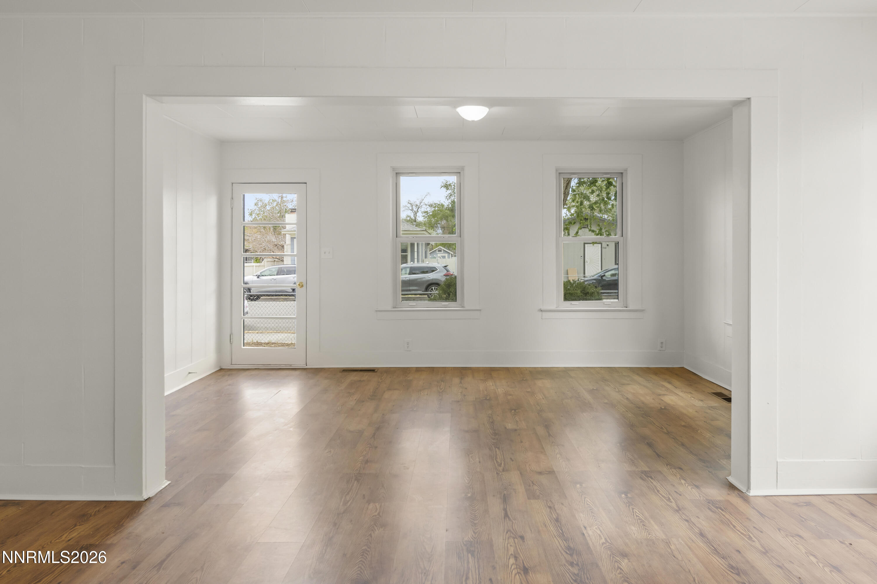 511 Churchill Street Fallon, NV 89406 - Photo 6 of 37 an empty room with wooden floor and windows