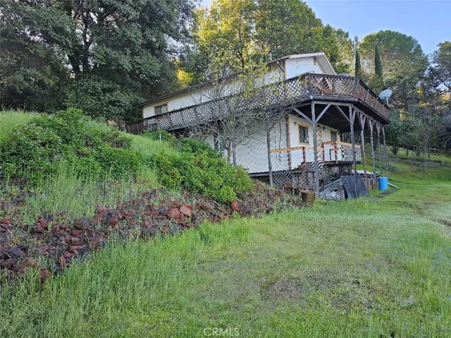a view of a house with a yard and sitting area