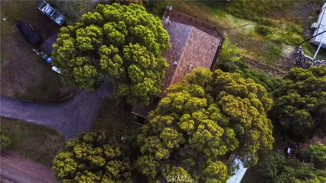 an aerial view of a house with a yard