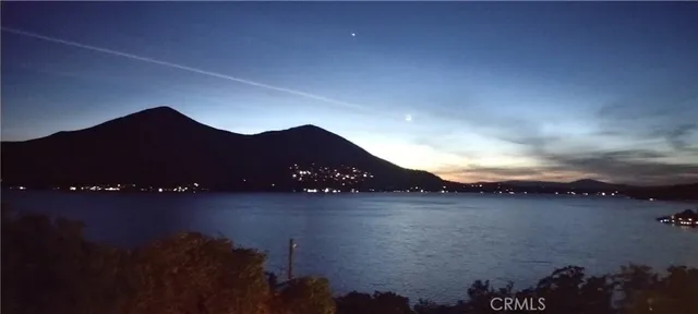 a view of a wooden chairs and a table in the balcony