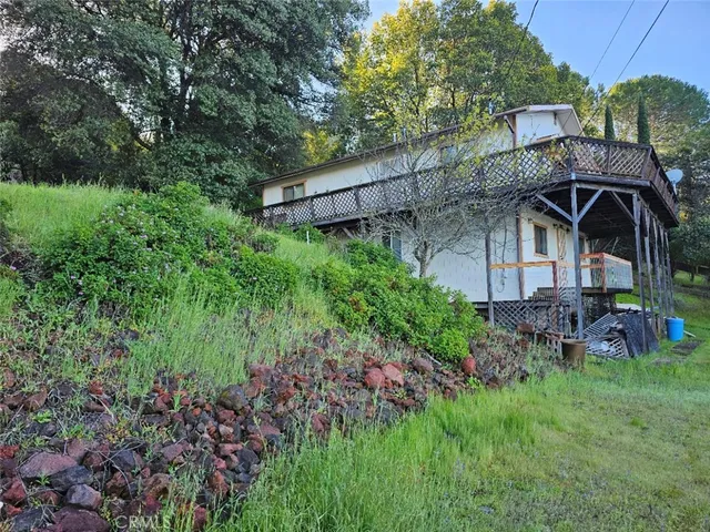 a view of porch with green trees in front