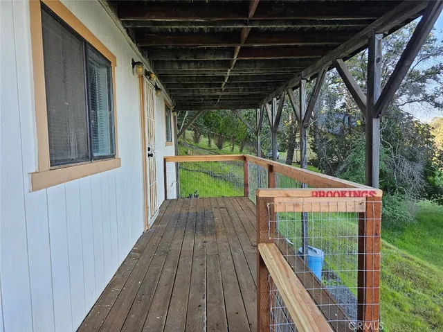 a view of a backyard with wooden fence and a bench