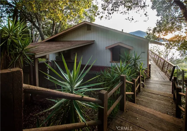 a living room with furniture and a refrigerator