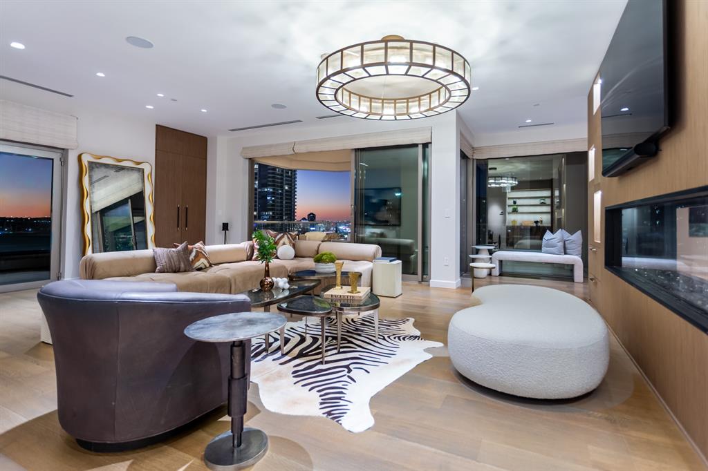 2300 Wolf Street, Unit 7D Dallas, TX 75201 - Photo 15 of 40 a living room with furniture a chandelier and a large window