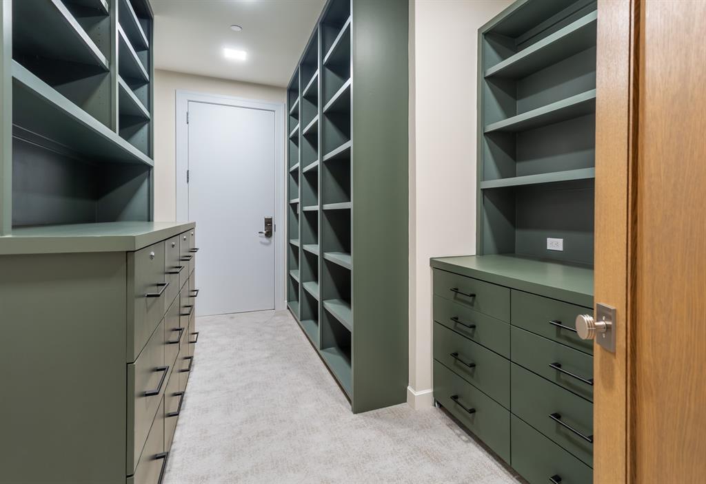 2300 Wolf Street, Unit 7D Dallas, TX 75201 - Photo 20 of 40 a view of walk in closet with clothes and shoes