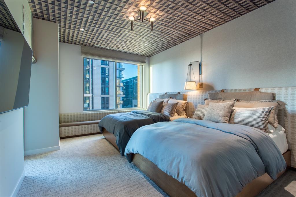 2300 Wolf Street, Unit 7D Dallas, TX 75201 - Photo 30 of 40 a spacious bedroom with two beds lamp and a large window