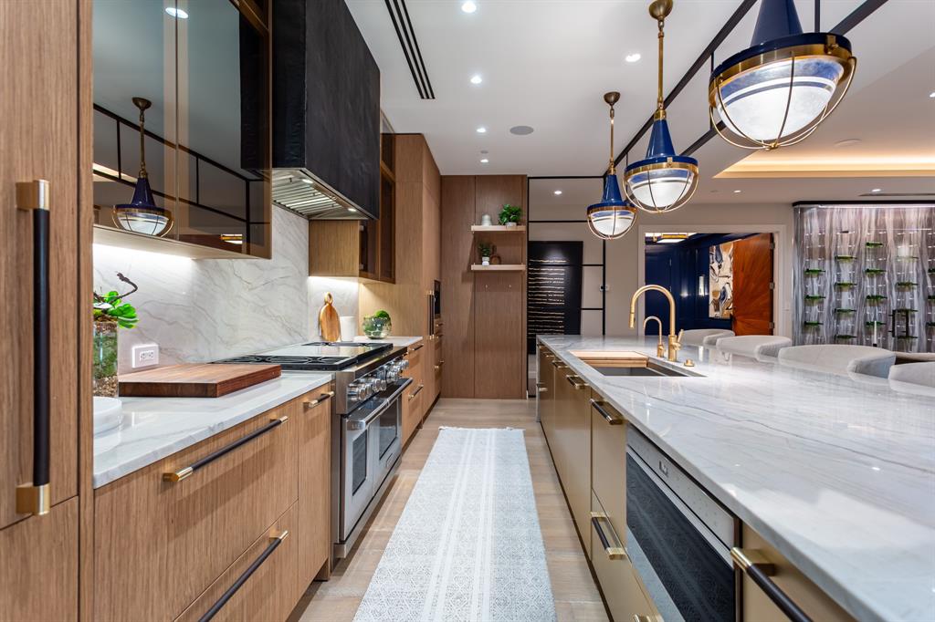 2300 Wolf Street, Unit 7D Dallas, TX 75201 - Photo 8 of 40 a large kitchen with stainless steel appliances granite countertop a lot of counter space and a large mirror