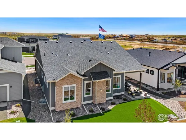 an aerial view of residential houses with outdoor space and ocean view
