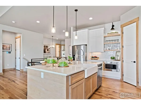 a kitchen with kitchen island a sink stove and refrigerator