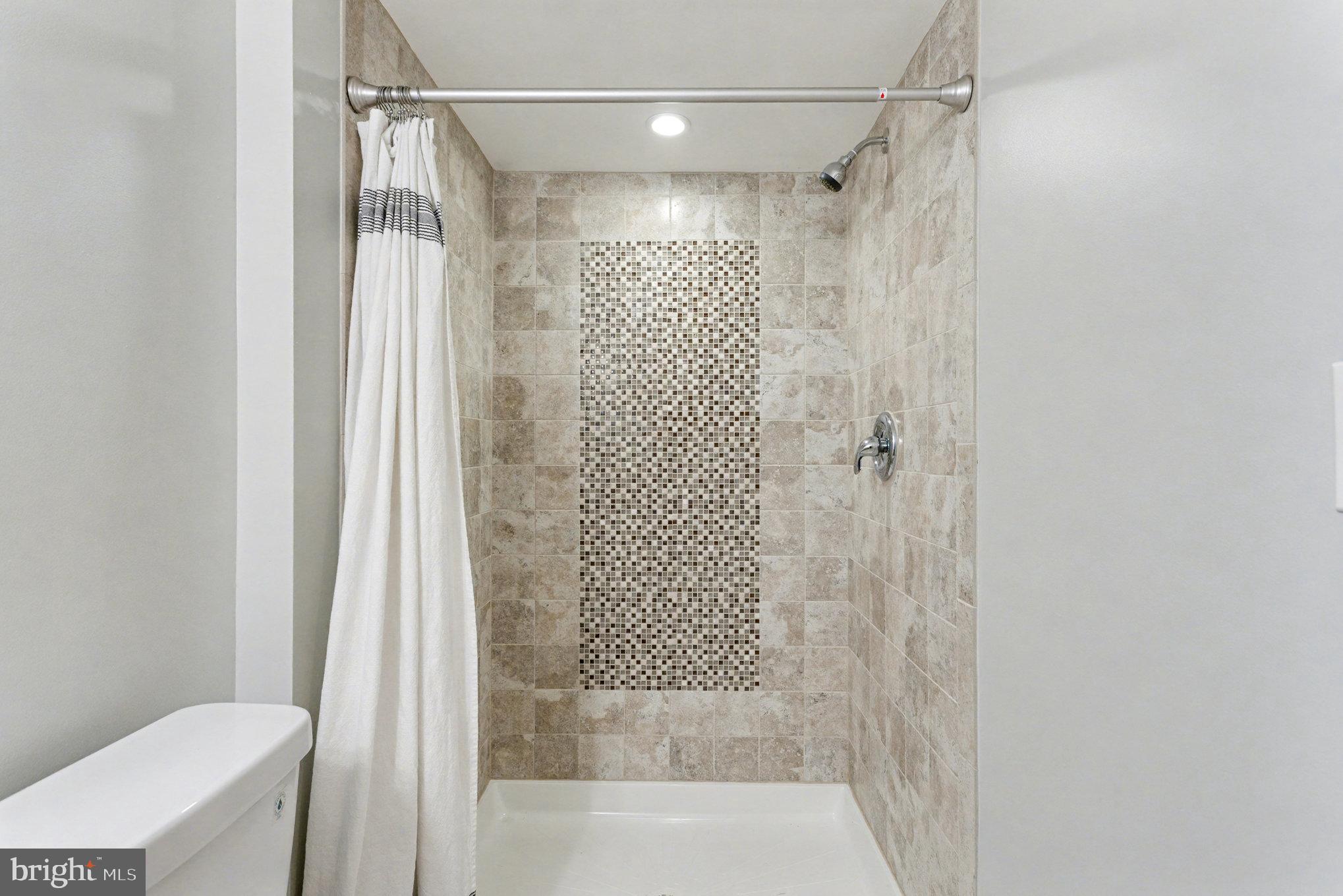 8656 Oak Road Baltimore, MD 21234 - Photo 18 of 30 a bathroom with a shower and a toilet