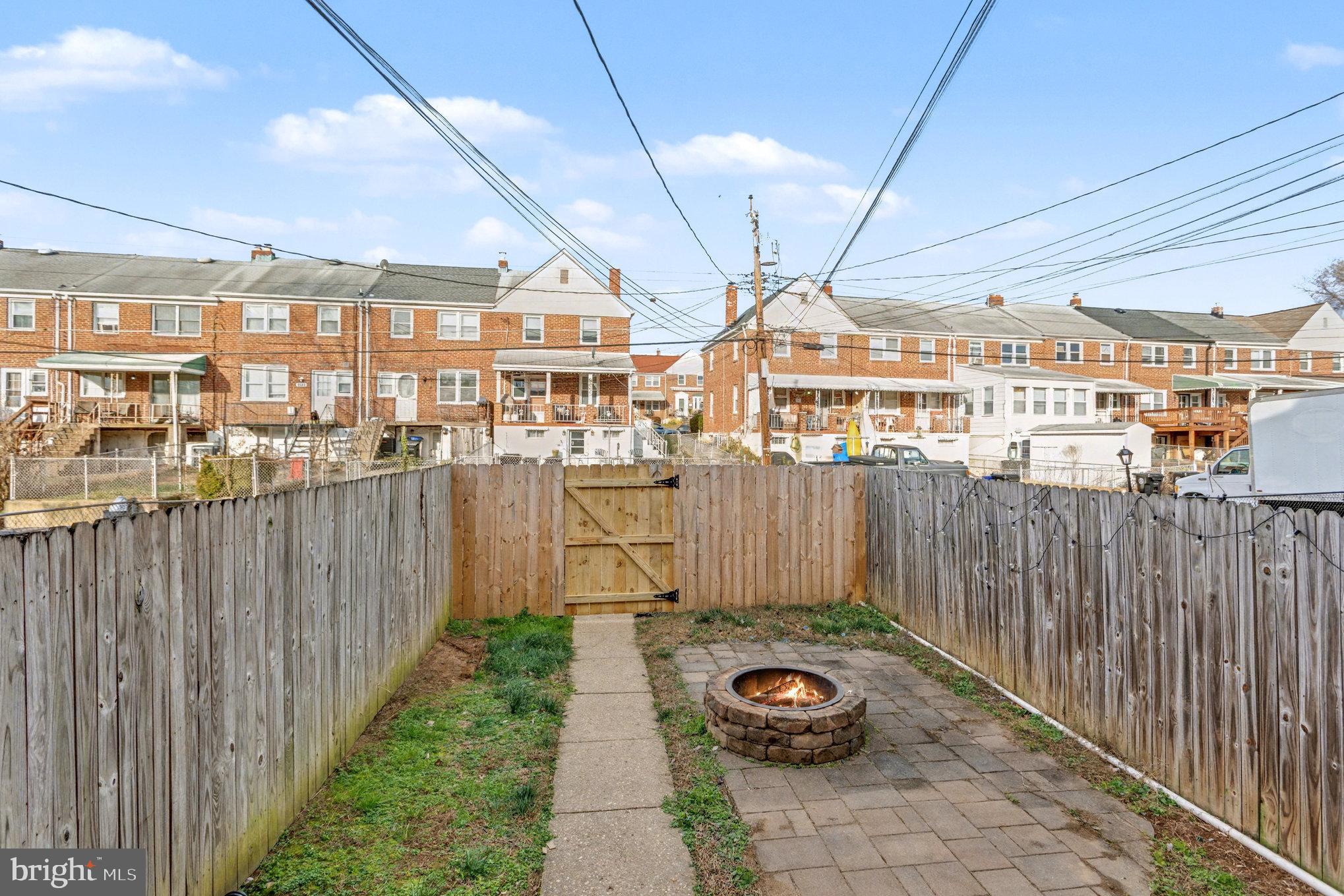 8656 Oak Road Baltimore, MD 21234 - Photo 24 of 30 a view of a patio with table and chairs and wooden fence