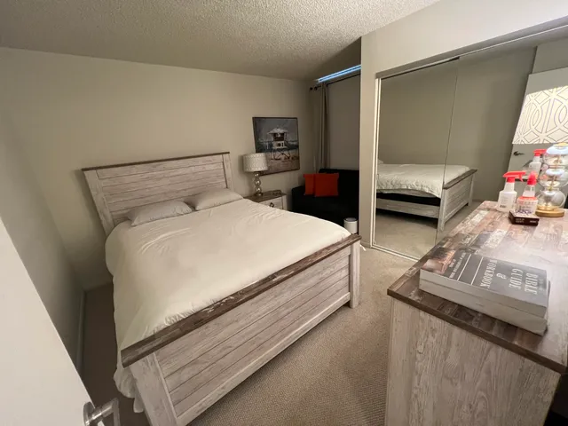 a spacious bedroom with a bed and a couch