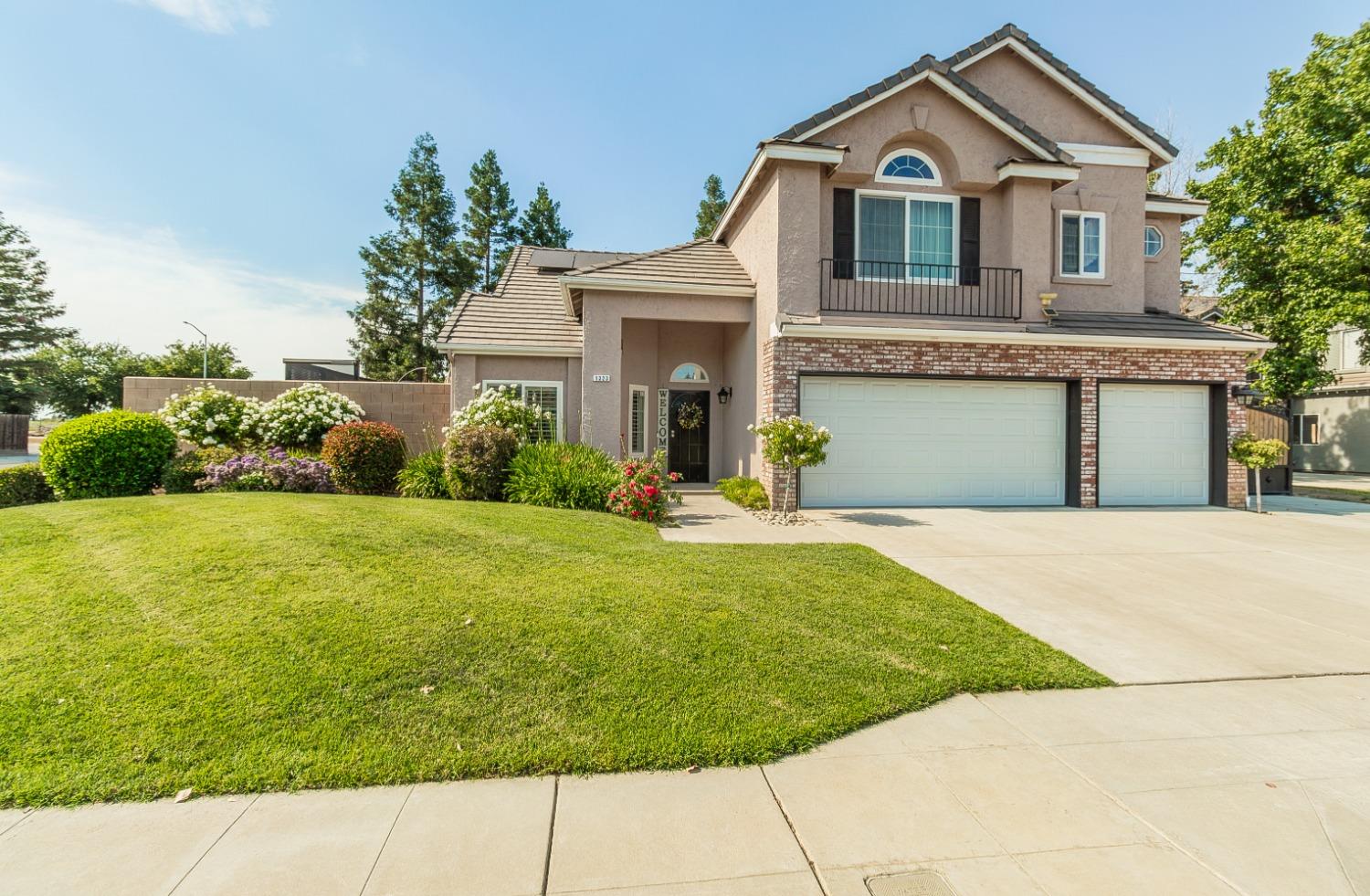 1323 Oak Avenue Clovis, CA 93611 - Photo 1 of 42 a front view of a house with garden