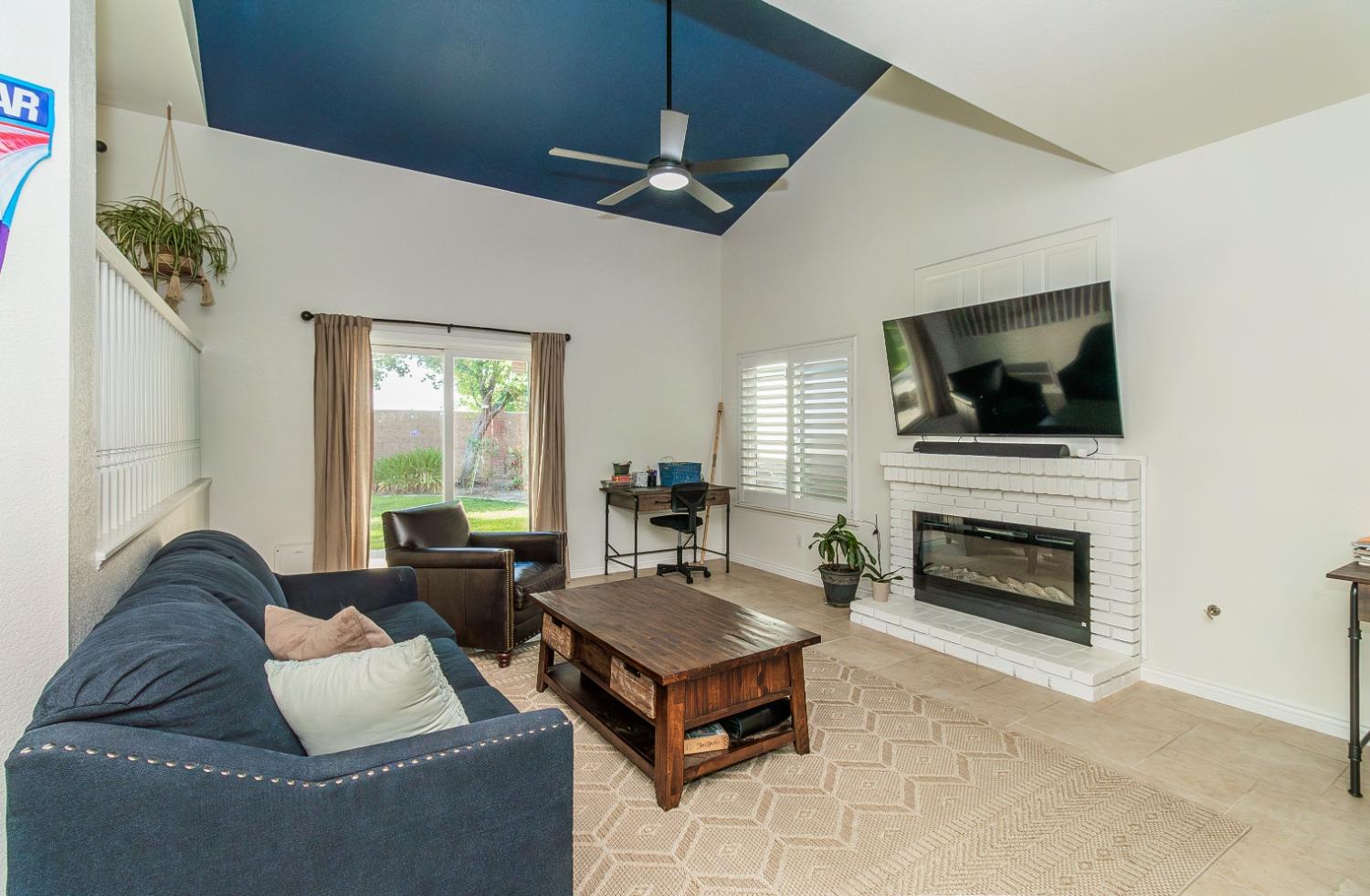 1323 Oak Avenue Clovis, CA 93611 - Photo 13 of 42 a living room with furniture and a fireplace