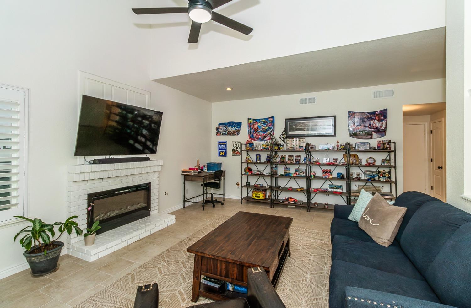 1323 Oak Avenue Clovis, CA 93611 - Photo 15 of 42 a living room with furniture and a flat screen tv