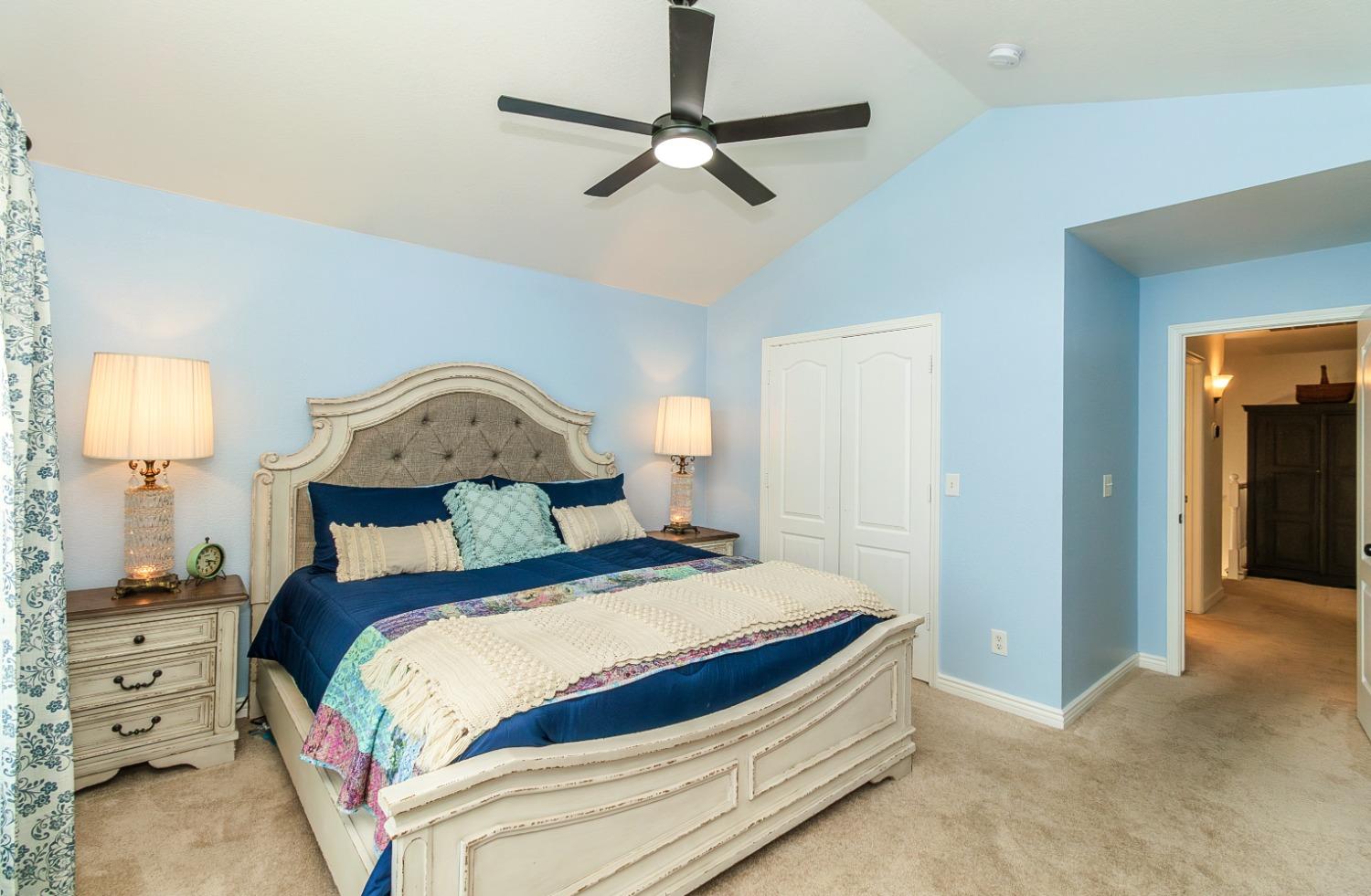 1323 Oak Avenue Clovis, CA 93611 - Photo 19 of 42 a bedroom with a bed and a lamp on a dresser