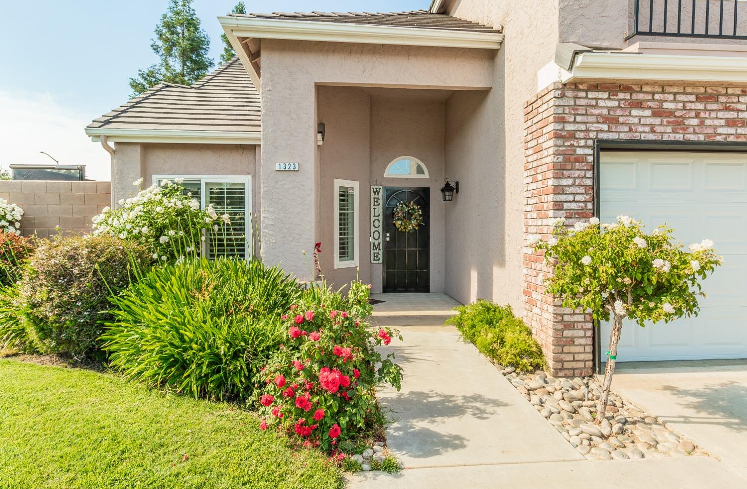 1323 Oak Avenue Clovis, CA 93611 - Photo 2 of 42 a front view of a house with a yard