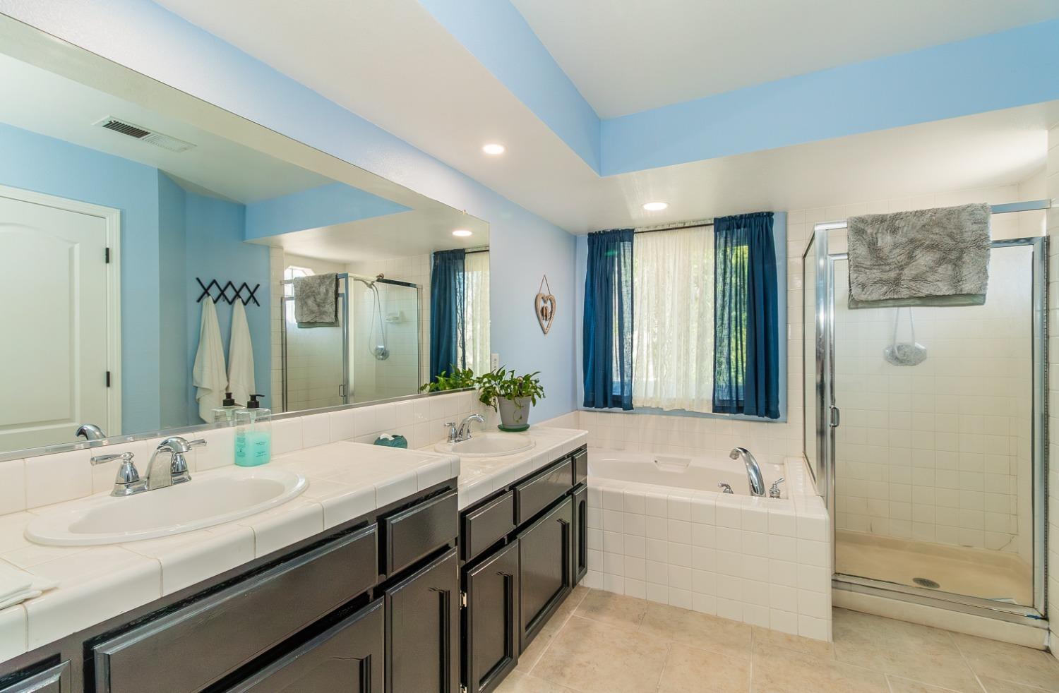 1323 Oak Avenue Clovis, CA 93611 - Photo 21 of 42 a bathroom with a double vanity sink mirror double and bathtub