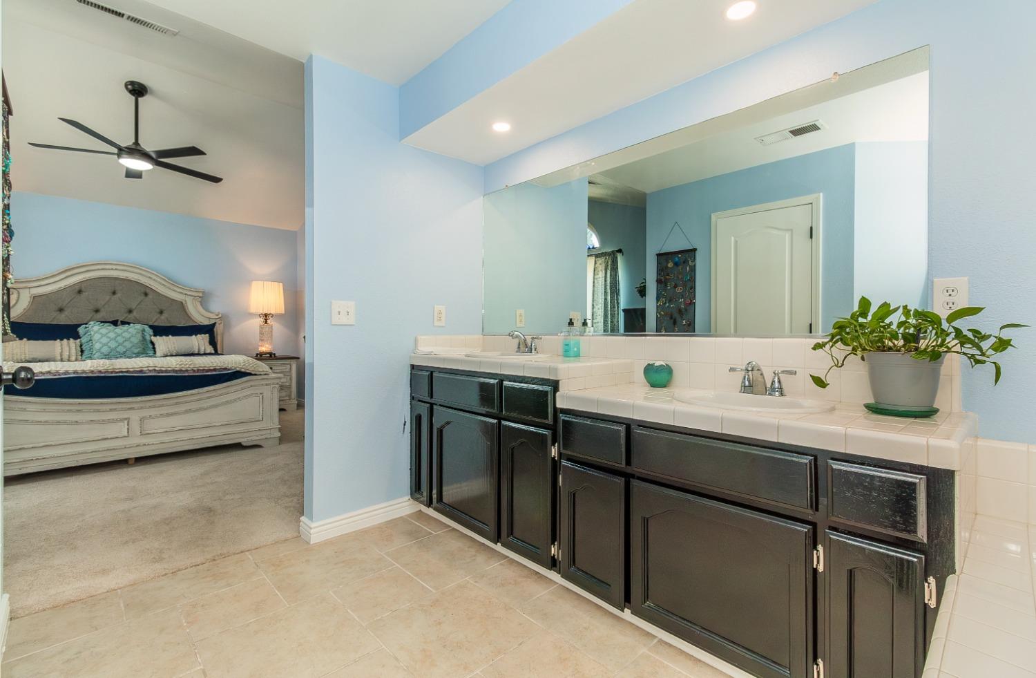 1323 Oak Avenue Clovis, CA 93611 - Photo 22 of 42 a bathroom with a sink and a mirror